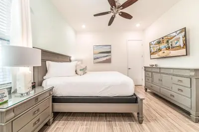 a bedroom with a bed and a ceiling fan at Ocean Waves Cottage With Private Pool Near Disney With Margaritaville Resort & Island H2O Access - 8001Su in Orlando