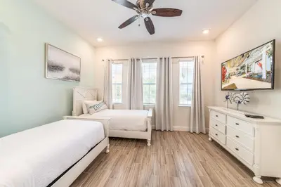 a bedroom with two beds and a ceiling fan at Ocean Waves Cottage With Private Pool Near Disney With Margaritaville Resort & Island H2O Access - 8001Su in Orlando
