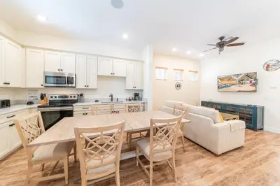 a kitchen and dining room with a table and chairs at Parrot Bay Cottage With Private Hot Tub Near Disney With Margaritaville Resort & Island H2O Access - 3067Kl in Orlando