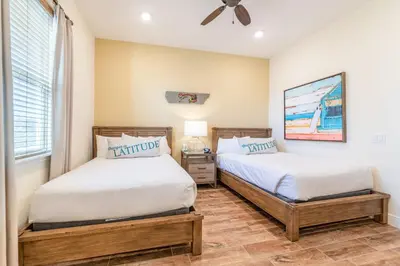 a bedroom with two beds and a window at Parrot Bay Cottage With Private Hot Tub Near Disney With Margaritaville Resort & Island H2O Access - 3067Kl in Orlando