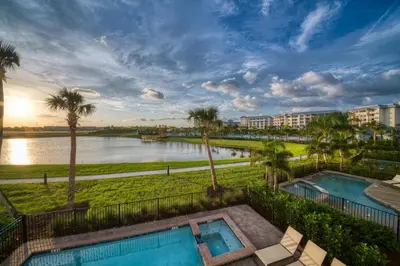 a view of a body of water with palm trees at It's All Fin & Games Cottage With Private Pool Near Disney & Margaritaville Resort & Island H20 Waterpark Access - 3090Ph in Orlando