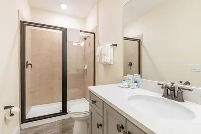 a bathroom with a shower and a toilet and a sink at High Tide Cottage With Private Pool Near Disney With Margaritaville Resort & Island H2O Access - 8053Su in Orlando