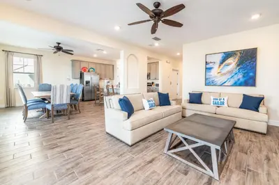 a living room with a couch and a table at High Tide Cottage With Private Pool Near Disney With Margaritaville Resort & Island H2O Access - 8053Su in Orlando