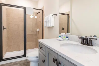 a bathroom with a shower and a sink and a toilet at High Tide Cottage With Private Pool Near Disney With Margaritaville Resort & Island H2O Access - 8053Su in Orlando