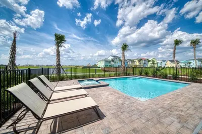 a pool with a bench and palm trees at High Tide Cottage With Private Pool Near Disney With Margaritaville Resort & Island H2O Access - 8053Su in Orlando