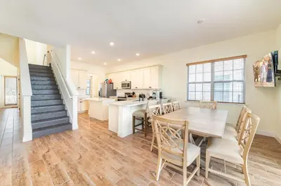 a kitchen and dining room with a table and chairs at Blissful Oasis With Private Pool Near Disney With Margaritaville Resort & Island H2O Access - 8057Su in Orlando