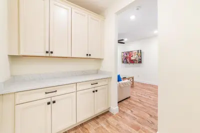 a kitchen with white cabinets and a hardwood floor at Blissful Oasis With Private Pool Near Disney With Margaritaville Resort & Island H2O Access - 8057Su in Orlando