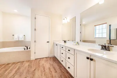 a white bathroom with two sinks and a tub and a tubermott at Blissful Oasis With Private Pool Near Disney With Margaritaville Resort & Island H2O Access - 8057Su in Orlando