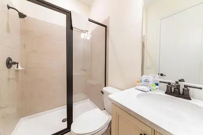 a bathroom with a shower and a toilet and a sink at Blissful Oasis With Private Pool Near Disney With Margaritaville Resort & Island H2O Access - 8057Su in Orlando