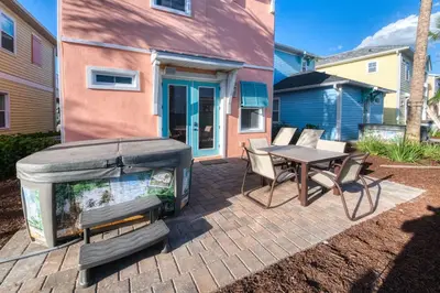 a patio with a large aquarium and a table and chairs at Fiesta Siesta Cottage With Hot Tub Near Disney With Margaritaville Resort & Island H2O Access - 8068Dr in Orlando