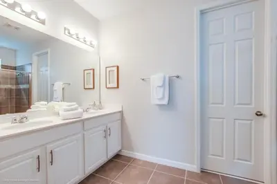 a white bathroom with a sink and a mirror at Solara Resort 9 Bedroom 6 Bathroom Resort Villa Villa in Orlando