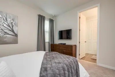 a bedroom with a bed and a flat screen tv at Solara Resort 9 Bedroom 6 Bathroom Resort Villa Villa in Orlando