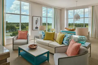 a living room with couches and chairs and windows at Gaylord Palms Resort & Convention Center in Orlando
