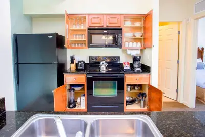 a kitchen with a stove and a refrigerator at Lake Buena Vista Resort Village and Spa, Near Disney in Orlando