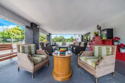 a living room with chairs and a table at Seasons Florida Resort in Kissimmee