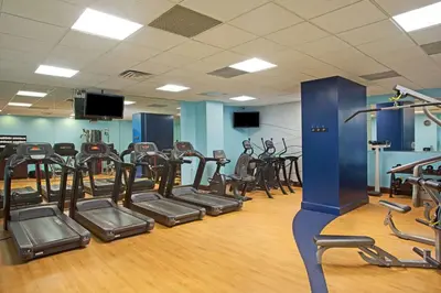 a gym with rows of exercise bikes and treadmills at Wyndham Lake Buena Vista – Disney Springs® Area in Orlando