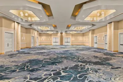 an empty ballroom with a large room with a large carpet at Delta Hotels by Marriott Orlando Celebration in Orlando