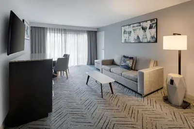 a living room with a couch and a table at Delta Hotels by Marriott Orlando Celebration in Orlando