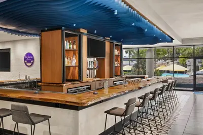 a bar with chairs and a blue ceiling at Delta Hotels by Marriott Orlando Celebration in Orlando