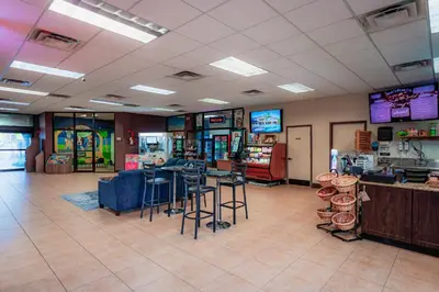 a room with bar stools and tables in a store at FantasyWorld Resort in Kissimmee