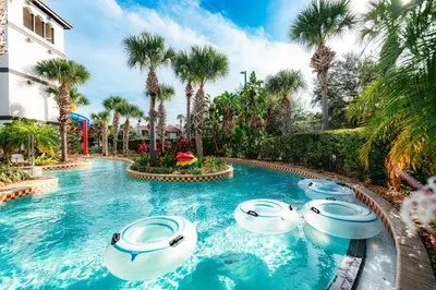 a pool at a resort with four inflatable boats in it at FantasyWorld Resort in Kissimmee