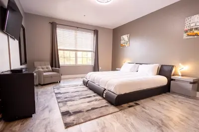 a bedroom with a large bed and a television at DISNEY PARKS- International Dr - Orlando Luxury Condominium- Fully Equipped - 3bed & 2 bath- in Orlando