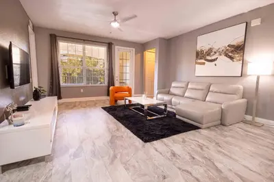 a living room with a couch and a table at DISNEY PARKS- International Dr - Orlando Luxury Condominium- Fully Equipped - 3bed & 2 bath- in Orlando