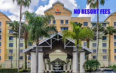 a building with a sign that reads no resort fees at Comfort Suites Maingate East in Orlando