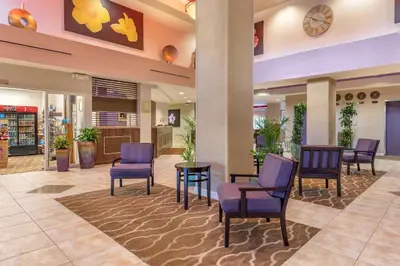 a waiting area at a hospital with chairs and tables at Comfort Suites Maingate East in Orlando
