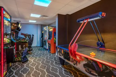 a room with arcade games and a video game console at Comfort Suites Maingate East in Orlando
