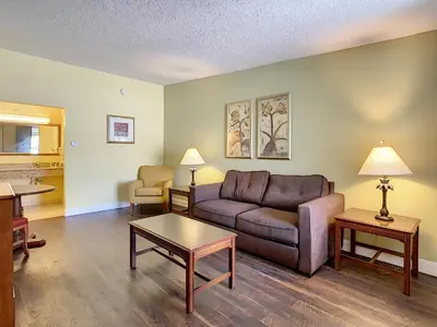 a living room with a couch and a table at Stayable Orlando at Florida Mall in Orlando