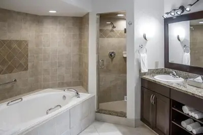 a bathroom with a tub and a sink at Hilton Vacation Club Polynesian Isles Kissimmee in Kissimmee