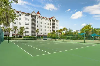 a tennis court in front of a large building at Hilton Vacation Club Grand Beach Orlando in Orlando