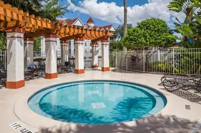 a swimming pool at a resort with a fence at Hilton Vacation Club Grand Beach Orlando in Orlando