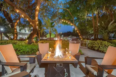 a fire pit in a patio with chairs and trees at Hilton Vacation Club Grande Villas Orlando in Orlando