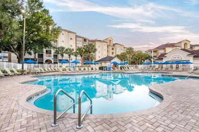 a pool at a resort with blue water and buildings at Hilton Vacation Club Grande Villas Orlando in Orlando