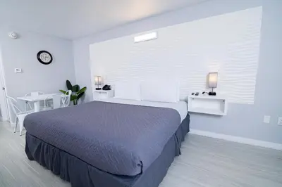 a bedroom with a bed and a table with a chair at Disney 12 minutes for family, Pool and parking FREE in Kissimmee