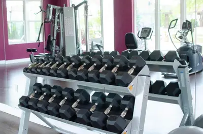 a gym with a rack of dumbbells at Amazing Townhouse in gated community 10' to Disney! in Kissimmee