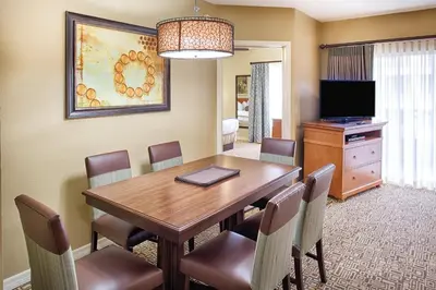 a dining room with a wooden table and chairs at Club Wyndham Cypress Palms in Kissimmee