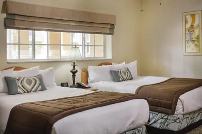 a hotel room with two beds and a window at Club Wyndham Cypress Palms in Kissimmee