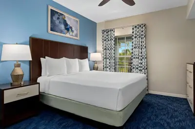 a bedroom with a large bed and a window at Club Wyndham Cypress Palms in Kissimmee