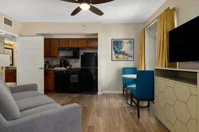 a kitchen and living room with a couch and a table at Club Wyndham Cypress Palms in Kissimmee