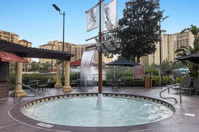 a small pool in a courtyard with tables and umbrellas at Club Wyndham Bonnet Creek in Orlando