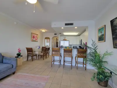 a kitchen and living room with a table and chairs at Lakeview Condo Hotel near Disney in Orlando