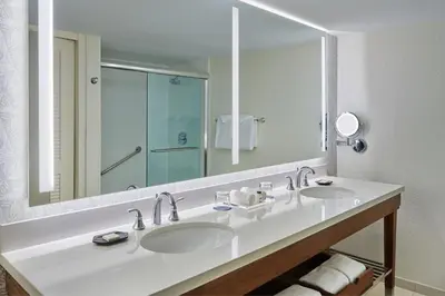 a bathroom with two sinks and a large mirror at Sheraton Orlando Lake Buena Vista Resort in Orlando