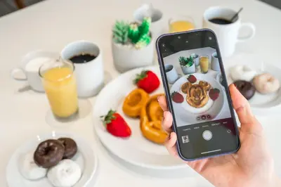 a person taking a picture of a plate of food at Sheraton Orlando Lake Buena Vista Resort in Orlando