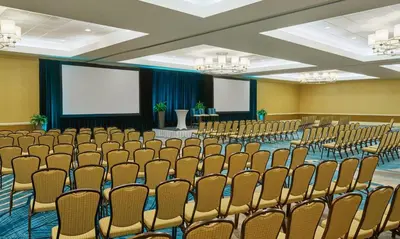 an empty conference room with chairs and a screen at Sheraton Orlando Lake Buena Vista Resort in Orlando