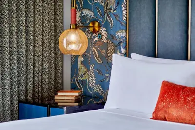 a bedroom with a bed and a blue wall at Grand Bohemian Orlando, Autograph Collection in Orlando