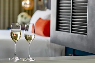 two glasses of white wine sitting on a table at Grand Bohemian Orlando, Autograph Collection in Orlando