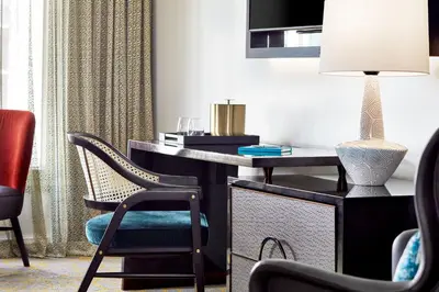 a desk with a chair and a lamp in a room at Grand Bohemian Orlando, Autograph Collection in Orlando